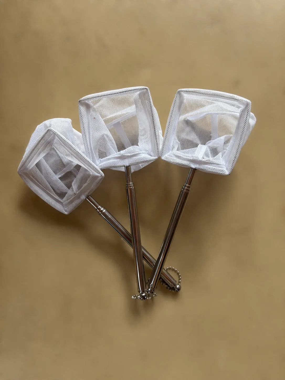 A 7cm square mesh aquarium net with an extendable telescopic handle for easy fish and shrimp catching.